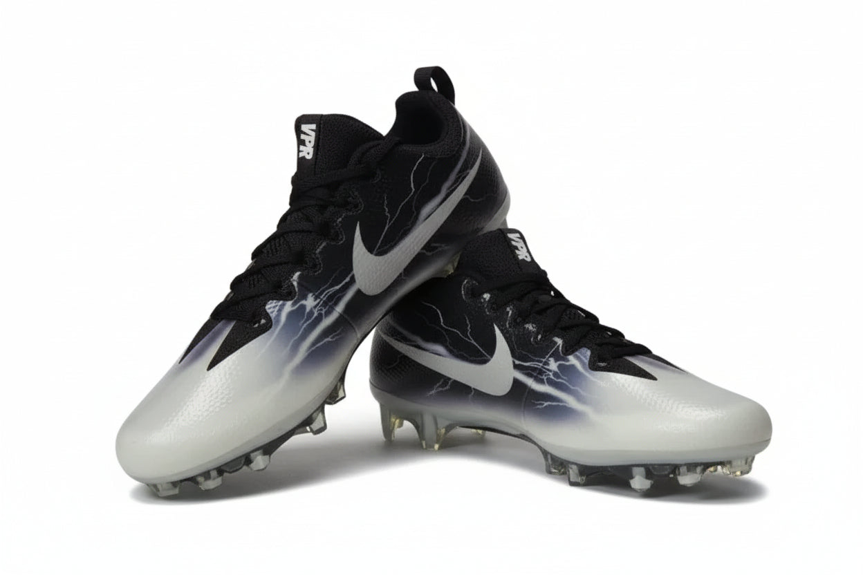 Nike Vapor Untouchable Pro Lightning football cleats in black and white shown on a light gray background